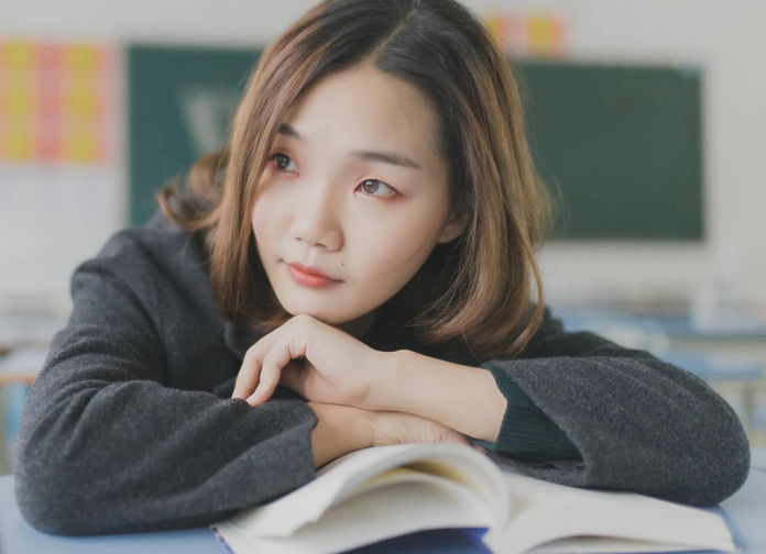 Asian female student with textbook