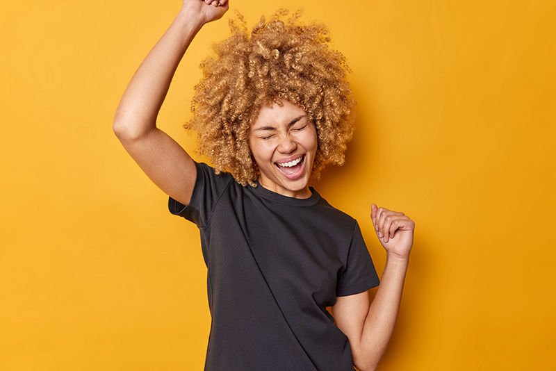 Cool woman with big hair demonstrates achievement.