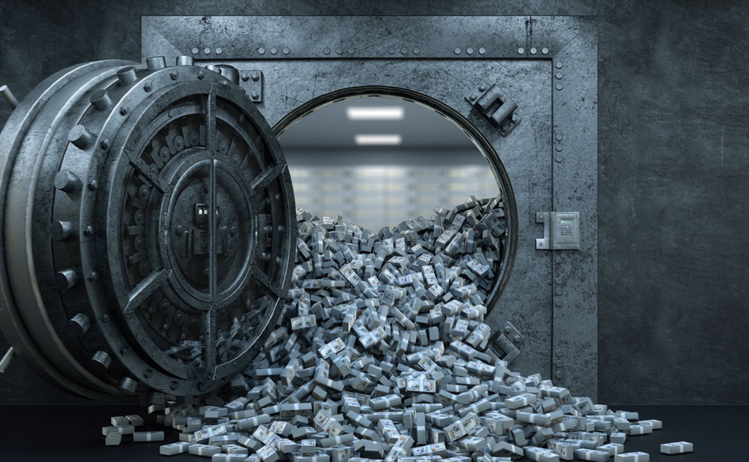 Open bank vault overflowing with cash.